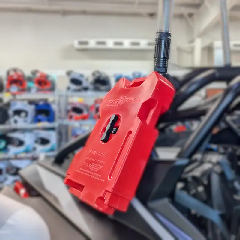 Rotopax gas can with spout attached and mounted on Polaris RZR in UTV dealership showroom