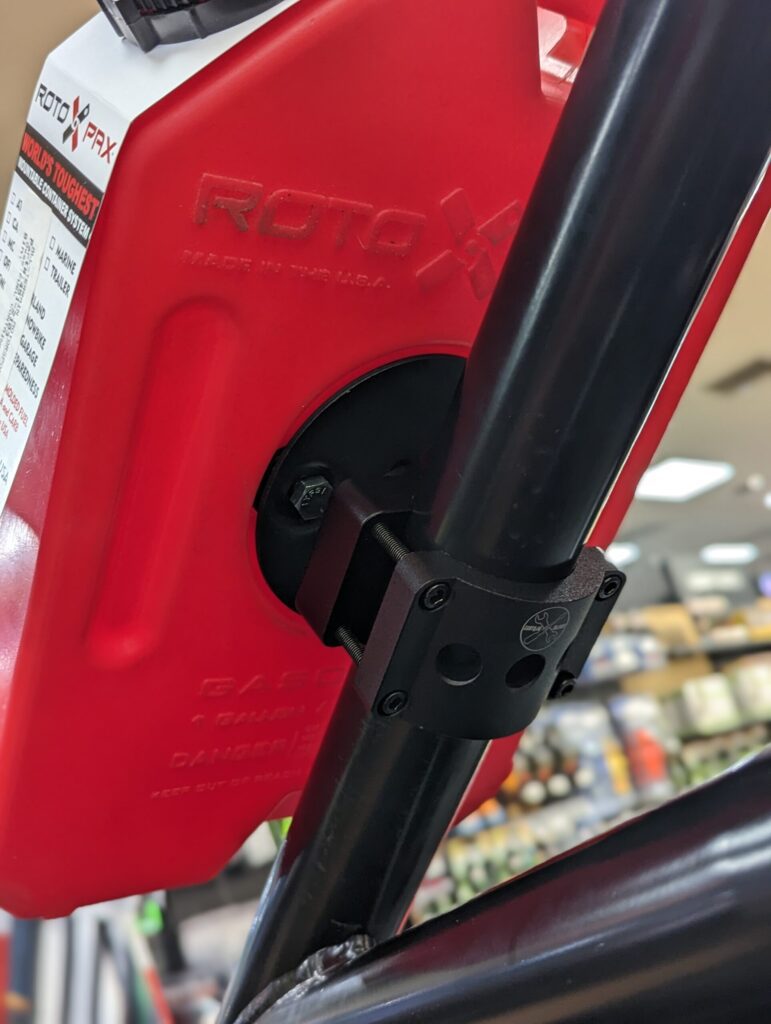 RotopaX UTV mount securely attached to a utility vehicle, holding fuel packs for off-road adventures