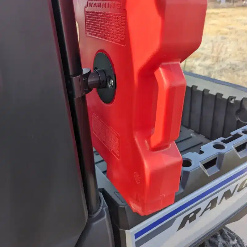 sideview of rotopax mount on a polaris ranger with a rear windshield