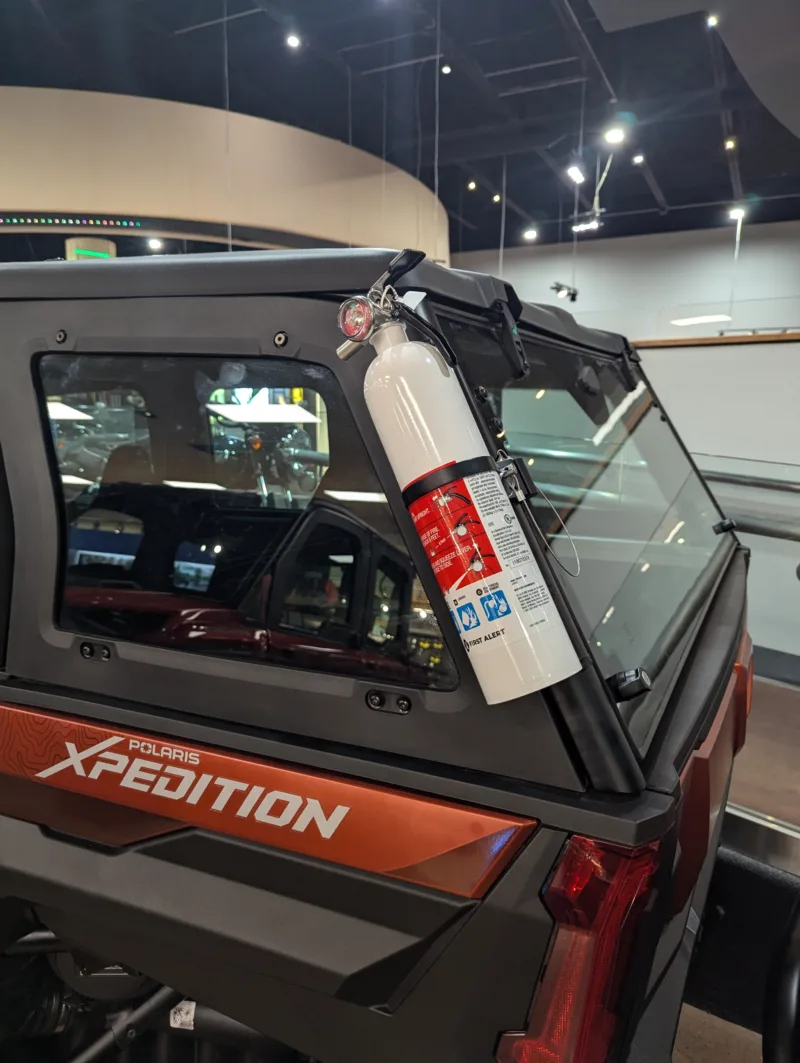 Adjustable fire extinguisher bracket demonstrated on Polaris Xpedition exterior