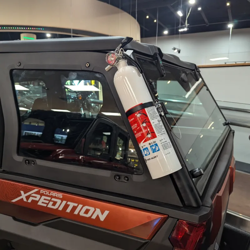 Adjustable fire extinguisher bracket demonstrated on Polaris Xpedition exterior