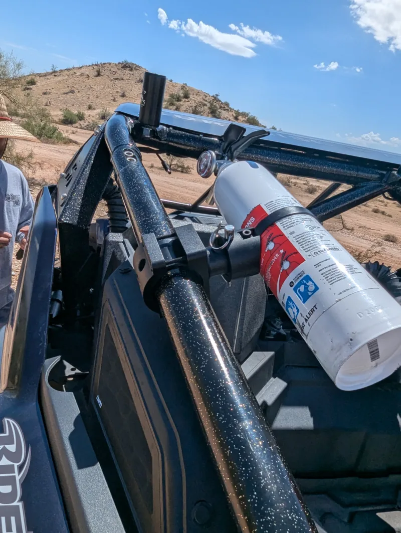 Best UTV fire extinguisher mount with quick release and 360° adjustability, shown mounted on a Polaris RZR Pro R with First Alert MARINE1