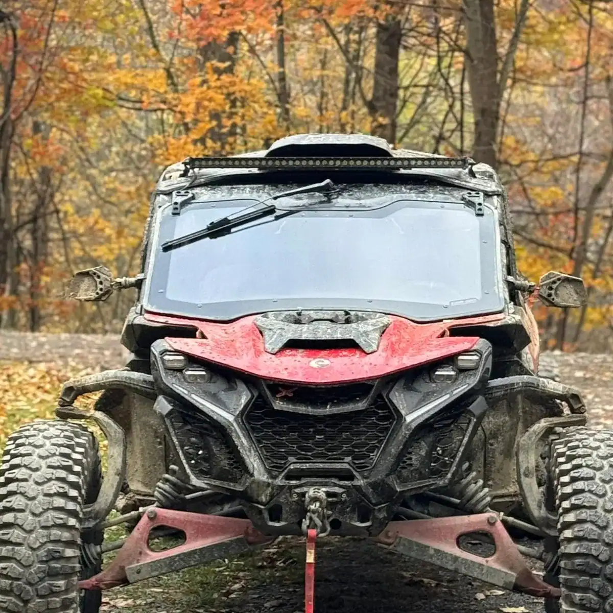 can-am maverick r facing front in east coast forest with billet mirrors