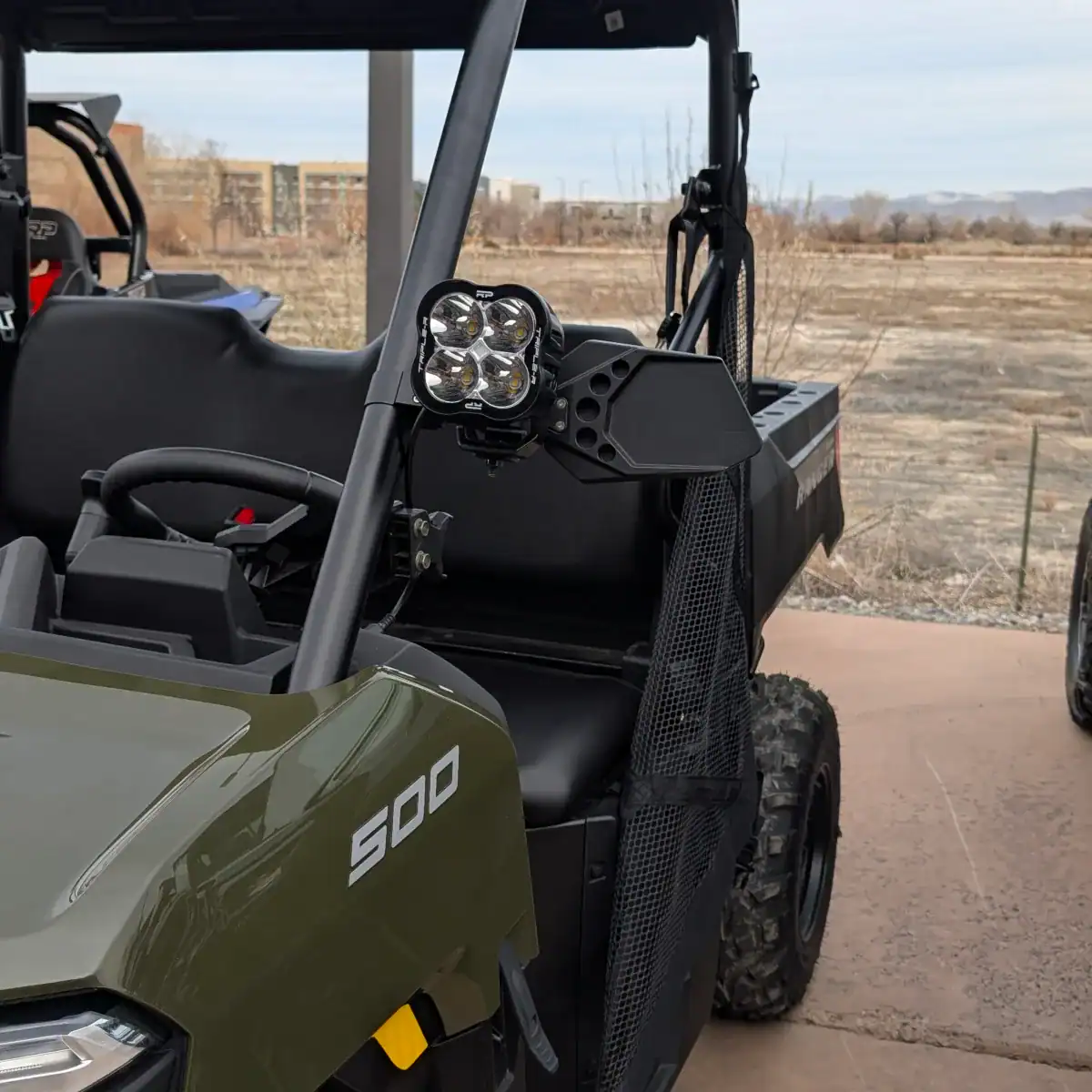 Polaris Ranger 500 with billet side mirror and pod light mounted on it